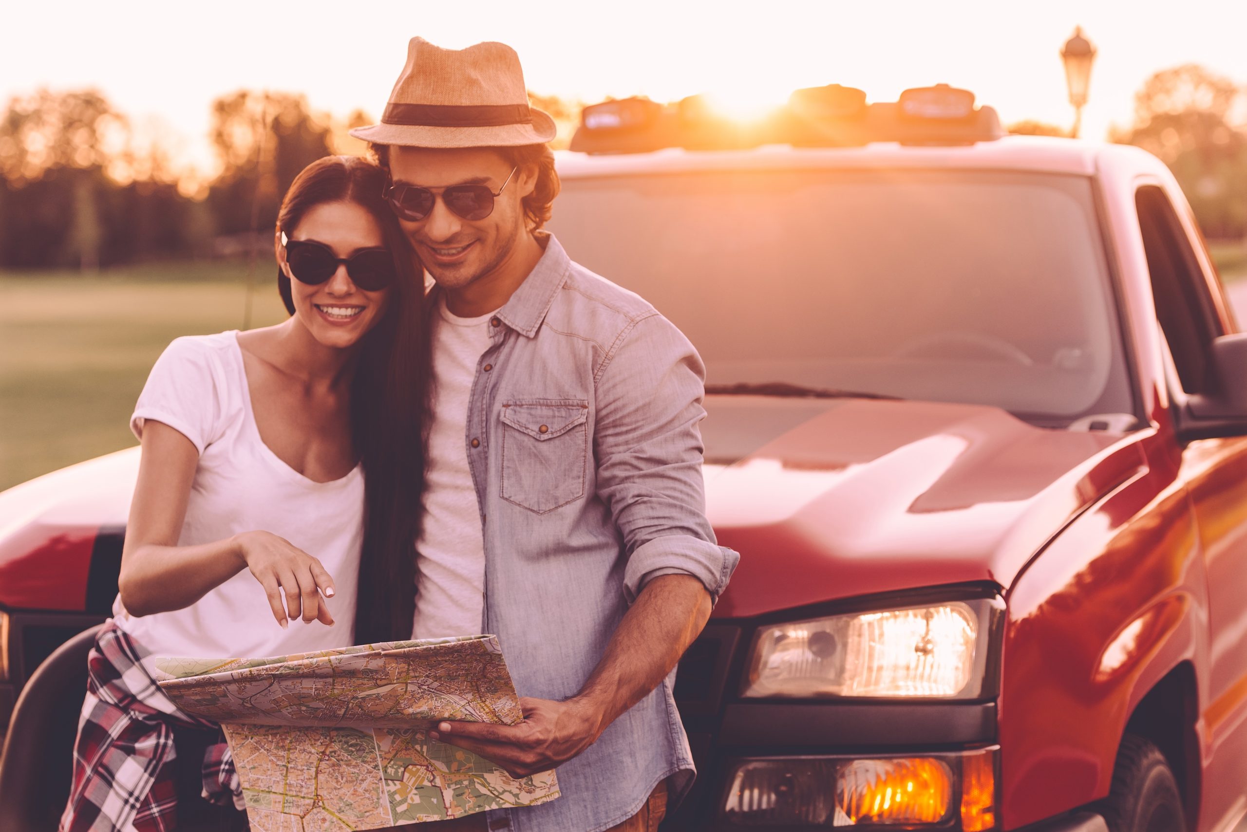 couple standing in front of pickup truck