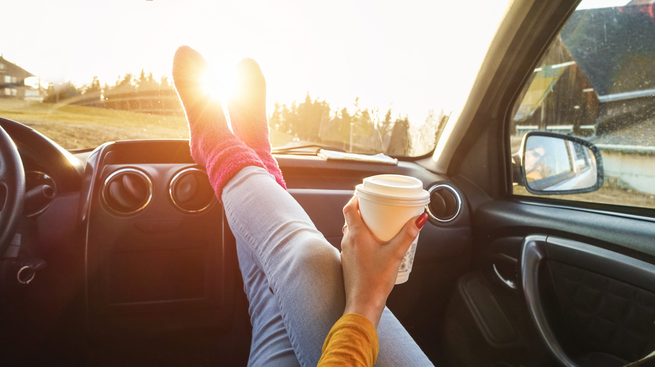 woman lounging in passenger seat of used car